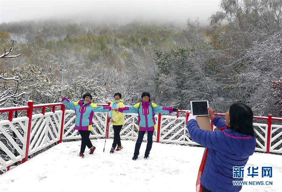 北京郊外で降雪　紅葉で色づく木々をすっぽり包む白い雪