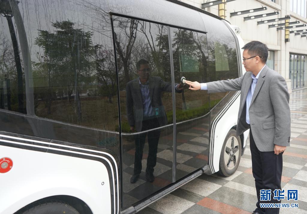 3月26日、雄安智絵未來科技園で、センサーにタッチして無人運転列車の乗降ドアを開ける、雄安デジタル交通実験室の任大凱さん（撮影?金皓原）。