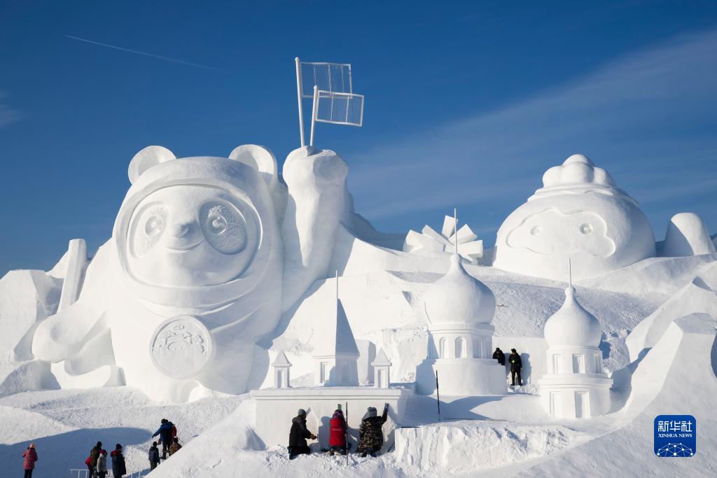 太陽島雪博會の會場で、メイン雪像「冬季五輪?太陽島の旅」の仕上げを行う作業(yè)員（撮影?張濤）。