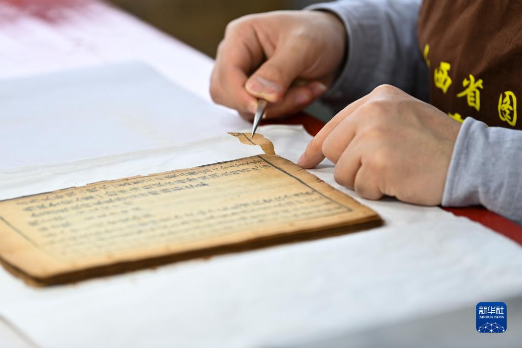 古書の「低侵襲手術(shù)」を行う若者　山西省